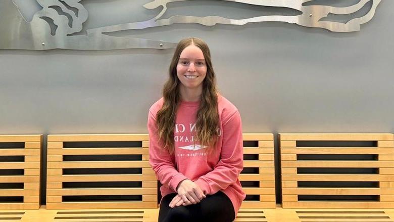 Photo of Sydney Bankert sitting in Gaige Building